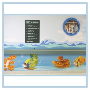 hallway-design-in-hospitals-healthcare-art-porthole-frame-3d-fish-and-waves