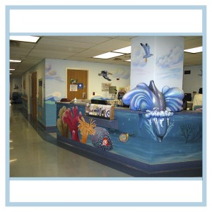 pediatric-unit-art-healthcare-design-murals-3d-fish-custom-bookcase-nurses-station-dolphin