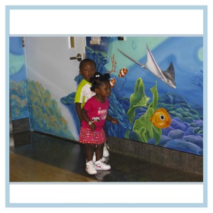 children-enjoying-artwork-healthcare-murals-3d-fish-underwater-theme